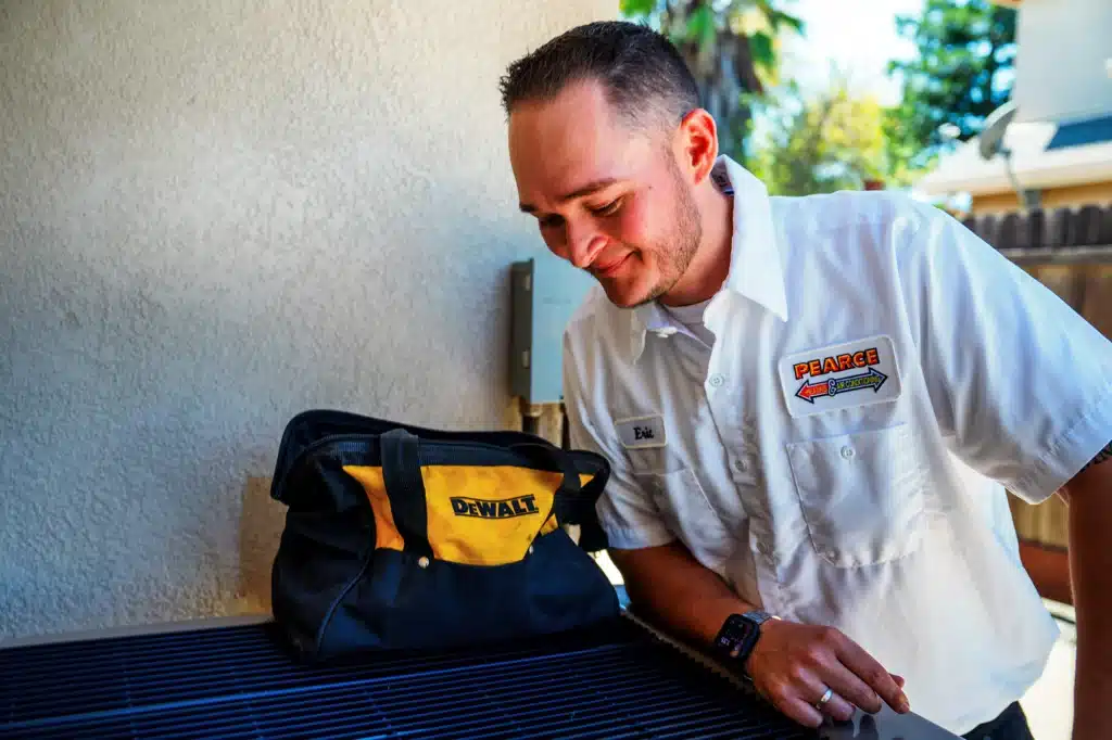 Pearce technician servicing HVAC unit